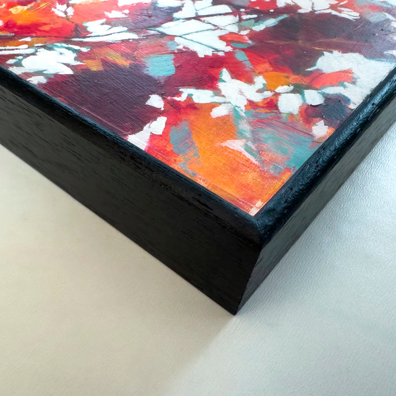 A close-up image showing a black wood frame and surface detail from A Live Tapestry of Leaves oil painting by Julia Brown
