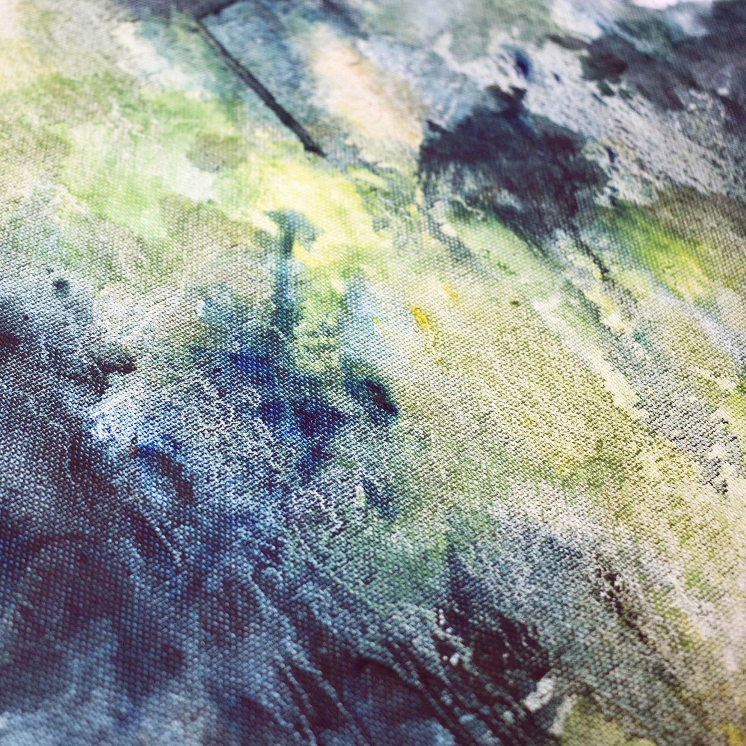 Surface detail of an oil painting of dappled summer light coming through leafy green trees by UK artist Julia Brown