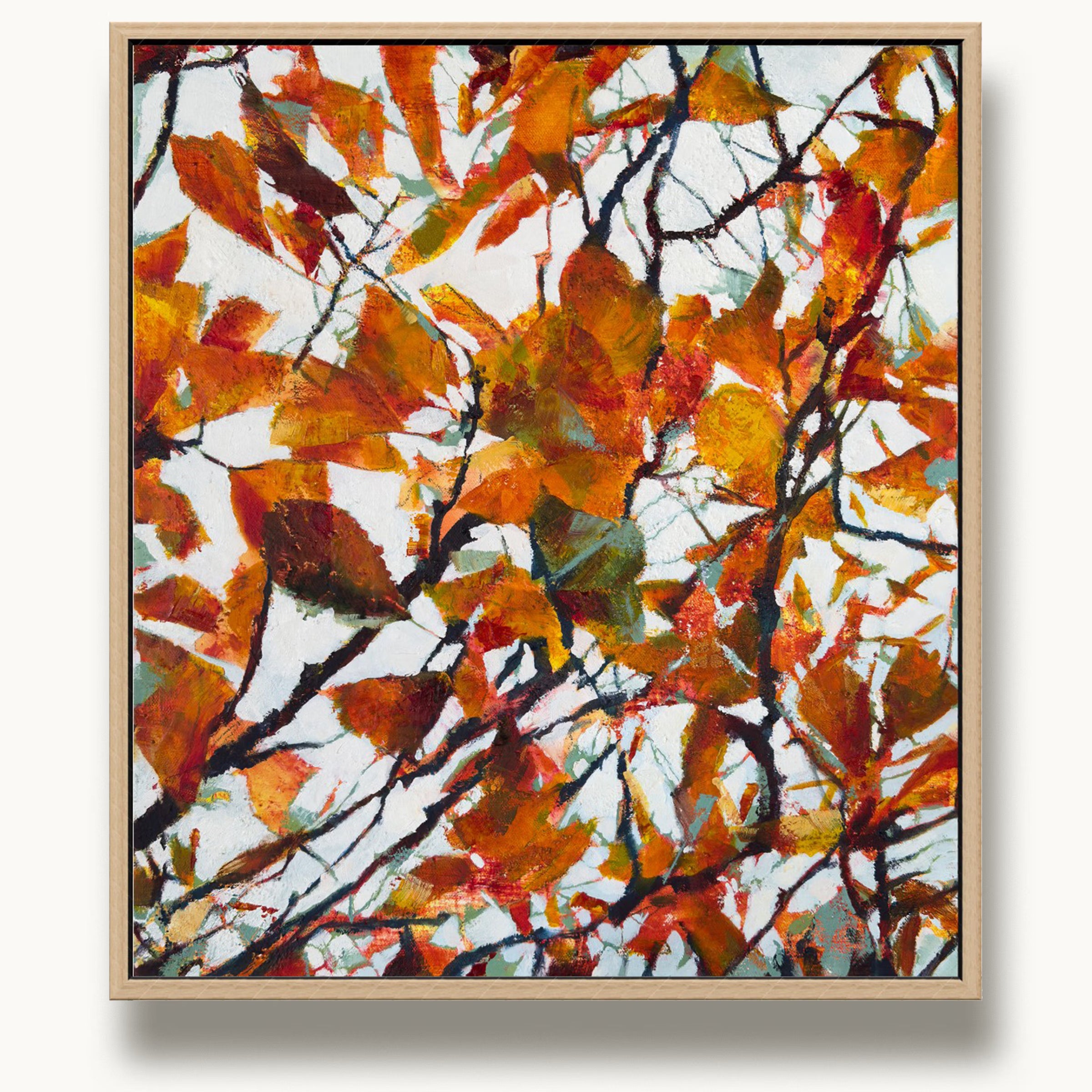 Small oak-framed abstract painting of autumn leaves by UK artist Julia Brown with vibrant orange, red, and teal colours on a white background.