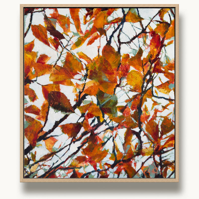 Small oak-framed abstract painting of autumn leaves by UK artist Julia Brown with vibrant orange, red, and teal colours on a white background.