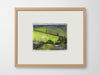 a framed artwork of fields on a white wall