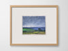 a framed artwork of fields on a white wall