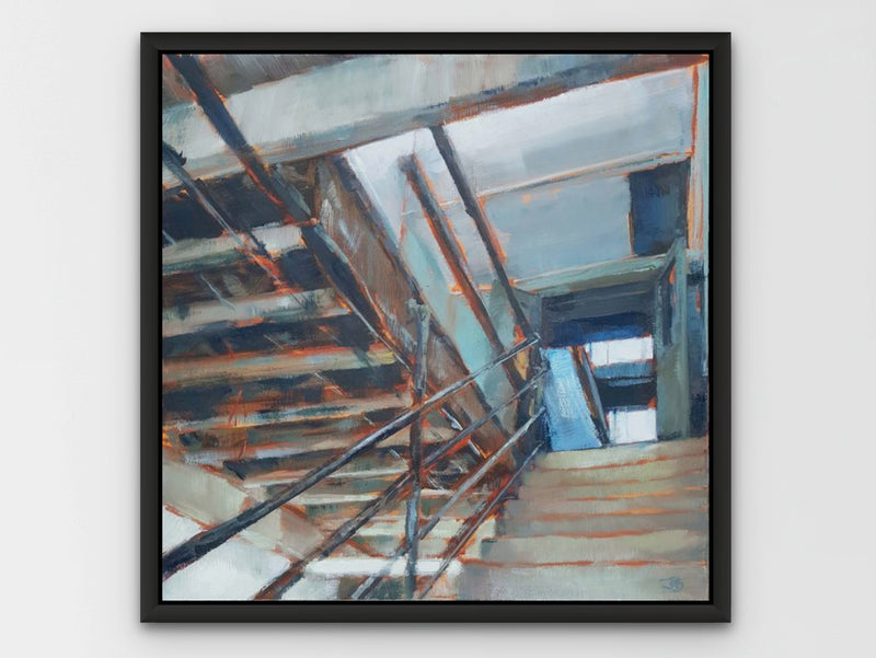 a framed painting of an industrial staircase on a white wall 