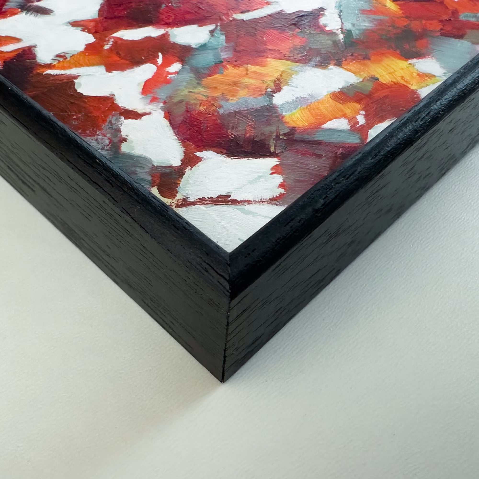 A close-up image showing a black wood frame and surface detail from Escape from the Grey oil painting by Julia Brown