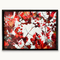 An abstract textured oil painting showing glimpses of bright light through branches with red, crimson and and teal maple leaves, in a black wood frame